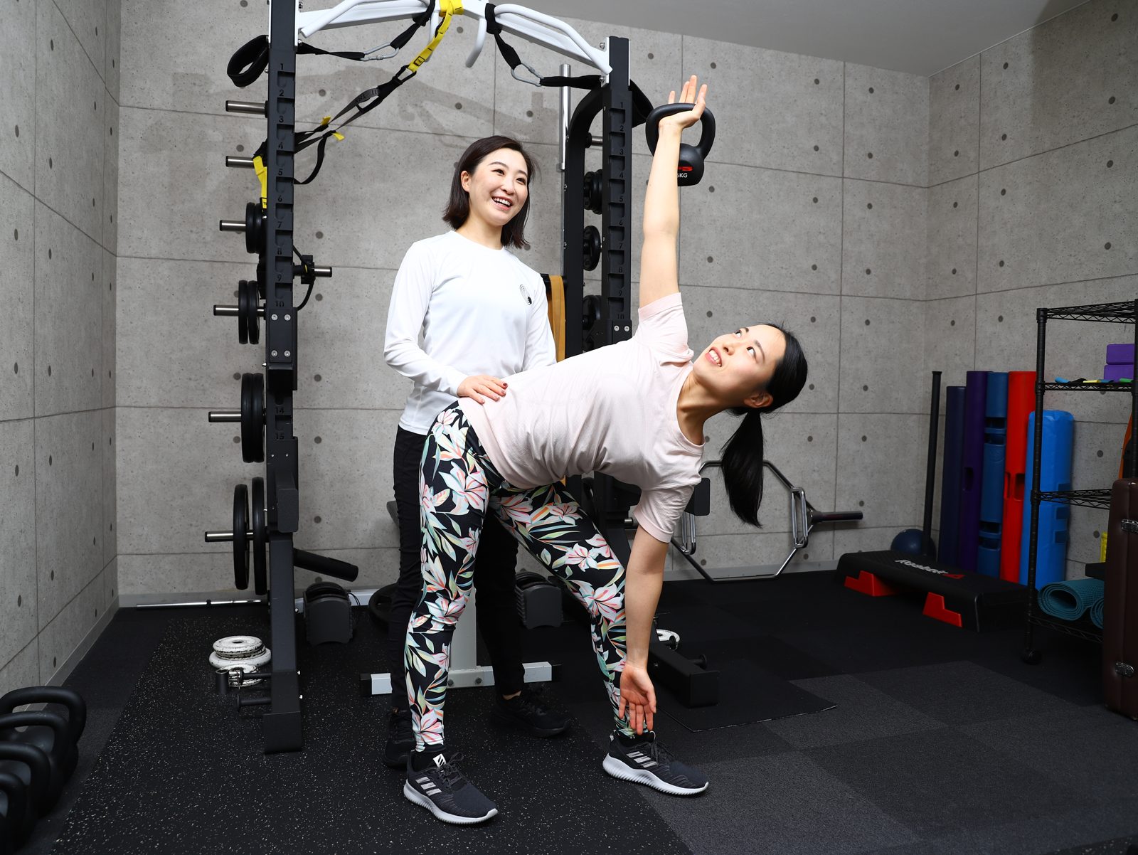 Body studio GRACE 北仙台のトレーナーが、ケトルベルを使ったトレーニングを笑顔でサポートする様子